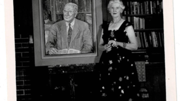 Marie Cruess standing in front of the Wm. Cruess portrait